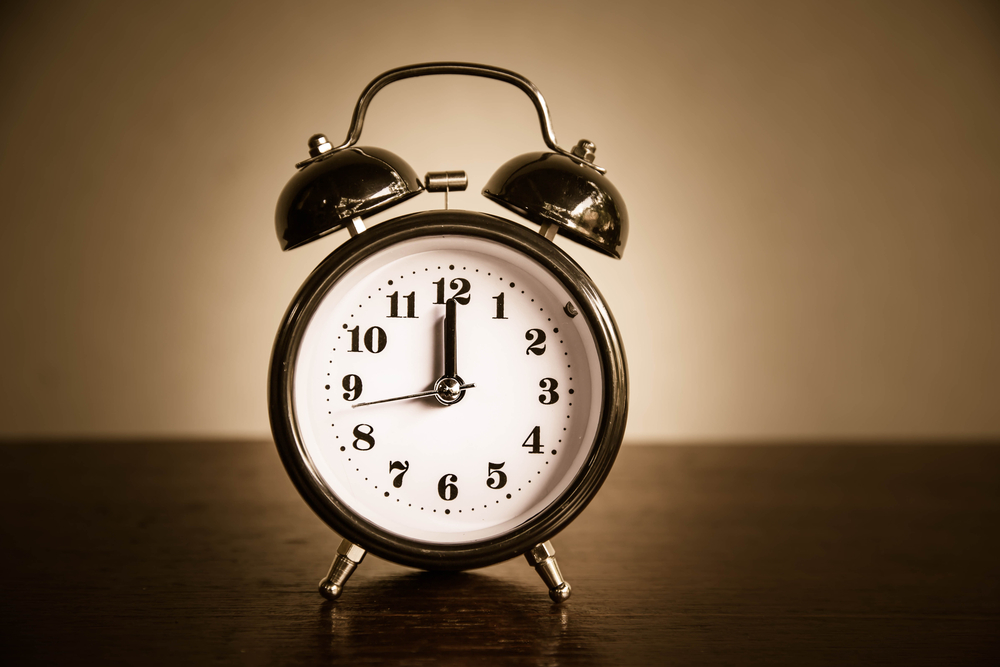 Retro alarm clock placed on a wooden table