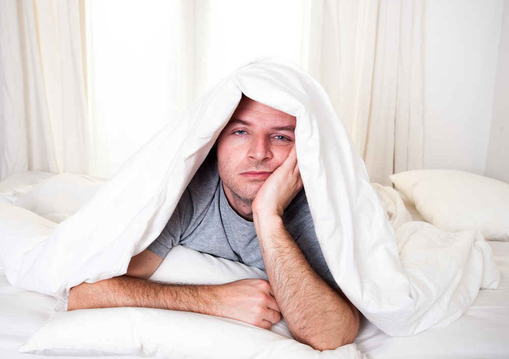 Man covered in duvet