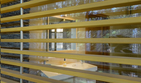 Wooden blinds resting against window