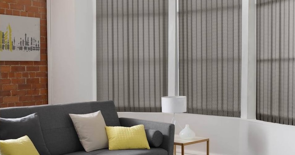 Grey vertical blinds with white lamp and yellow cushions