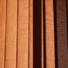 a close up of a window with brown blinds